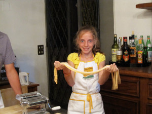 A joyous young student with her pasta dough in our Italian culinary school