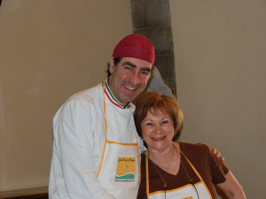 An excited student posing with her Italian chef